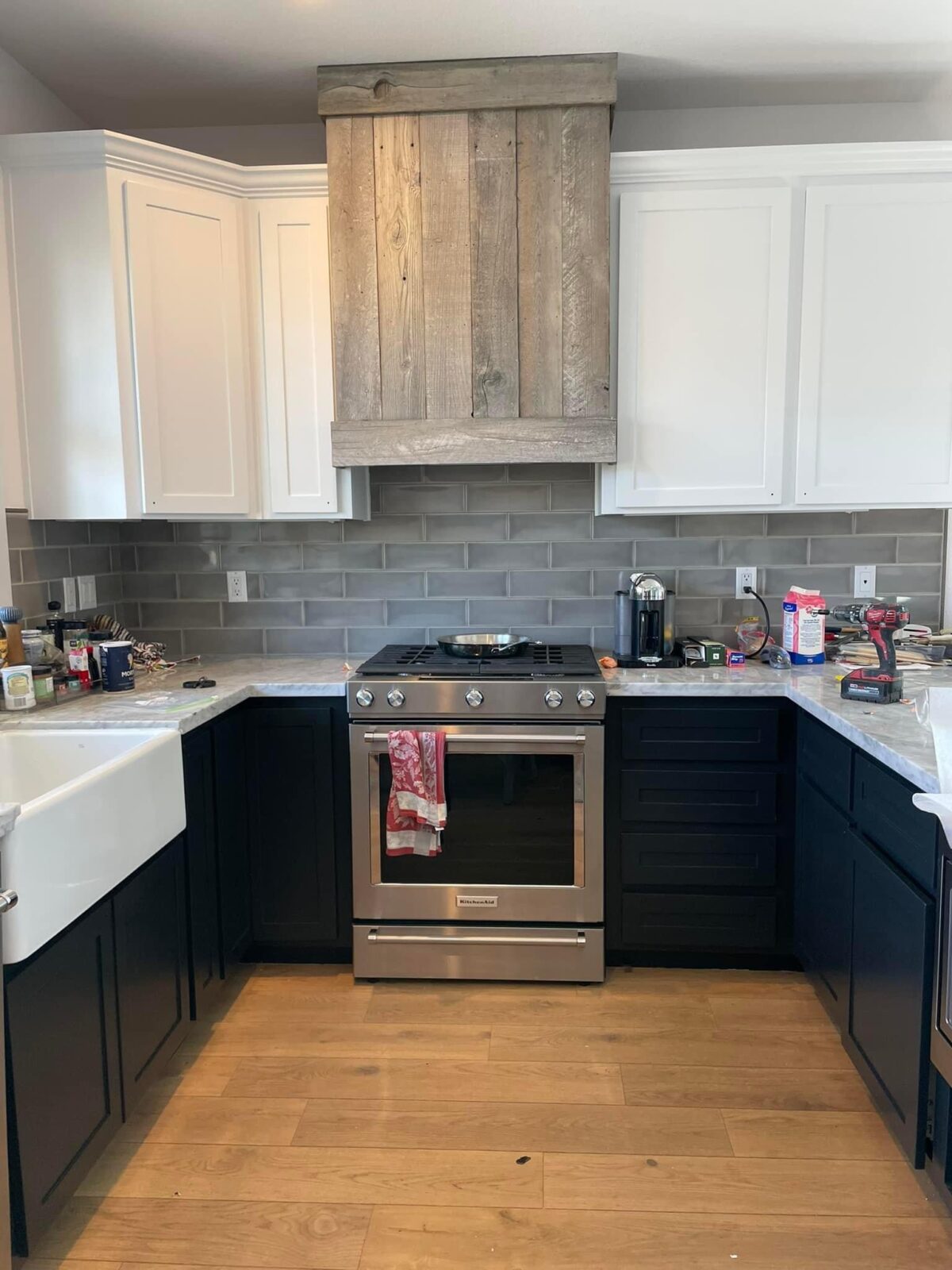 Kitchen with white upper and dark lower painted cabinets