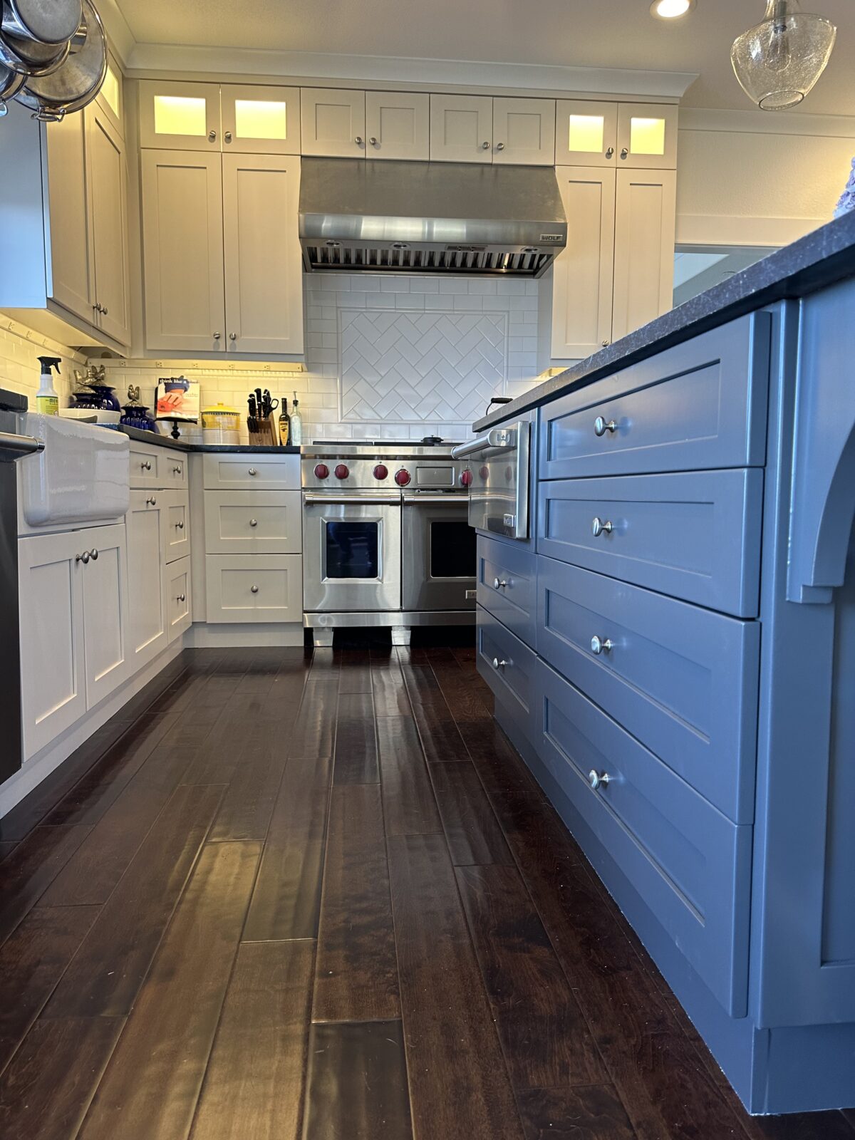 White kitchen with a blue painted island